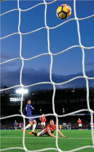  ?? GETTY ?? Manchester United’s David De Gea clears the ball while under pressure from Chelsea’s Alvaro Morata at Stamford Bridge