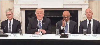  ?? CHIP SOMODEVILL­A, GETTY IMAGES ?? President Trump with members of his American Technology Council, including, left to right, Apple CEO Tim Cook, Microsoft CEO Satya Nadella and Amazon CEO Jeff Bezos at the White House on Monday.