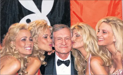  ?? AP PHOTO ?? In this May 14, 1999, photo, Playboy founder and editor in chief Hugh Hefner receives kisses from Playboy playmates during the 52nd Cannes Film Festival in Cannes, France. Hefner has died at age 91. The magazine released a statement saying Hefner died...