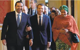  ?? Philippe Wojazer / AFP / Getty Images ?? French President Emmanuel Macron (center) with Lebanon's Prime Minister Saad Hariri (left) and UN Deputy Secretary General Amina Mohammed.