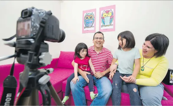  ?? GERRY KAHRMANN ?? Lino Coria and his wife Marcela de la Pena record a video with daughters Julia and Emilia in their Port Moody home. The engineer is known to YouTube fans in his native Mexico for sharing the family’s life in Canada. “People think of immigrants, sometimes, in a very cartoony way,” he says, explaining his videos are an opportunit­y to show the variety of stories.