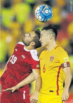  ??  ?? China’s Feng Xiaoting vies for the ball with Mardek Mardkian of Syria in a June 13 World Cup qualifier that resulted in a 2-2 draw and all but sank China’s chances of advancing to the 2018 tournament.