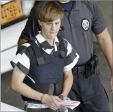  ?? CHUCK BURTON — THE ASSOCIATED PRESS FILE ?? In this file photo, Charleston, S.C., shooting suspect Dylann Storm Roof is escorted from the Cleveland County Courthouse in Shelby, N.C. The sentencing phase of Roof’s federal trial begins Wednesday in Charleston. He could face the death penalty or...