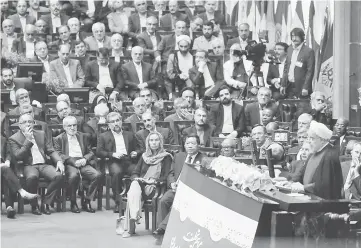  ??  ?? Mogherini (front left) listens as Rouhani (right) delivers a speech after being sworn in before parliament in Tehran. — AFP photo