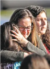  ?? John McCall / South Florida Sun-Sentinel ?? Students console each other after it was all over the day of the Parkland, Fla., massacre of Feb. 14.