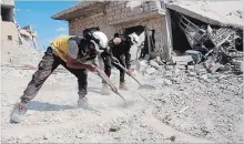  ?? THE ASSOCIATED PRESS ?? A Syrian civil defence group known as the White Helmets clean rubble from a house damaged by a Syrian government airstrike near Idlib.