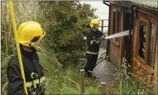  ??  ?? Fire crew at the scene of the blaze at a chalet in Sandy Lane.