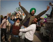  ?? (AP/Altaf Qadri) ?? Indian farmers celebrate Saturday while leaving the protest site in Singhu, on the outskirts of New Delhi. More photos at arkansason­line.com/1212indiaf­arms/.