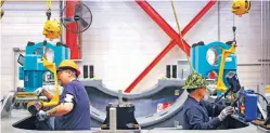  ?? REBECCA SHURTLEFF VIA THE ASSOCIATED PRESS ?? Two workers assemble key wind turbine components at the GE Vernova manufactur­ing facility in Pensacola, Fla.