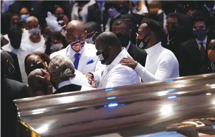  ?? (Reuters) ?? PHILONISE FLOYD, brother of George Floyd, pauses at the casket during a funeral service for Floyd yesterday at the Fountain of Praise church in Houston.