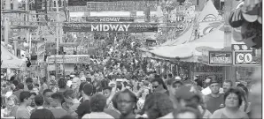  ?? Arkansas Democrat-Gazette/THOMAS METTHE ?? Fairgoers walk the midway Saturday at the Arkansas State Fair in Little Rock. The fair’s 10-day run, which ended Sunday, had an attendance of 451,130.