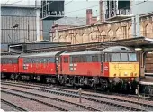  ??  ?? Wet conditions often meet photograph­ers at Carlisle which was the case when this view of No. 86416 with BGs was taken in September 1994. It was withdrawn in early 2002 and scrapped in July 2005.