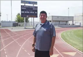  ?? KARINA LOPEZ PHOTO ?? Southwest High’s Ruben Valenzuela smiles for a photo on Eagle Field earlier this week. Valenzuela took over the athletic director position after Joe Evangelist’s retirement in May.