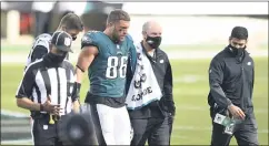  ?? DERIK HAMILTON - THE ASSOCIATED PRESS ?? Tight end Zach Ertz, center, walks off the field with the members of the Eagles training staff after suffering an ankle injury against the Baltimore Ravens on Sunday. Ertz will miss Thursday’s game against the New York Giants.