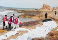  ?? EPA ?? Volunteers of the Red Crescent recover bodies washed ashore near the Libyan coastal district of Zawiya on Monday.