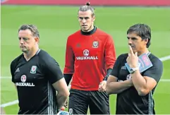  ??  ?? National duty: Chris Coleman (right) wants to pick Gareth Bale (centre) in March