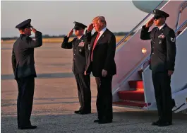  ??  ?? President Donald Trump salutes as he arrives on Air Force One on Saturday in Andrews Air Force Base en route to Washington to attend an event at the Kennedy Centre for the Performing Arts. — AP