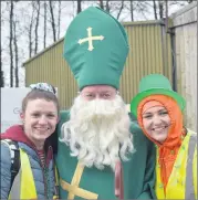  ?? (Photo: Katie Glavin) ?? Twins Maeve and Ciara Sheehan, who work together at Glennon Brothers, getting a special blessing from St Patrick (William Murphy) as the parade got underway - a fundraiser for Fermoy Community Hospital.