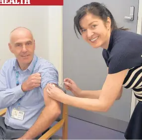  ??  ?? Flu jab Calum Campbell with nurse Pauline Shannon