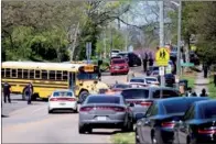  ?? REUTERS ?? Police respond to a shooting at Austin-East Magnet High School in Knoxville, Tennessee, on Monday. A male with a gun was killed, and a police officer was wounded.