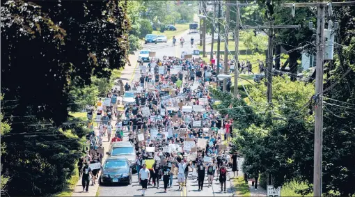  ?? KASSI JACKSON/HARTFORD COURANT ?? Manchester residents march against police brutality Saturday from Manchester Town Hall to the parking lot of Illing Middle School next to the Manchester Police Department.