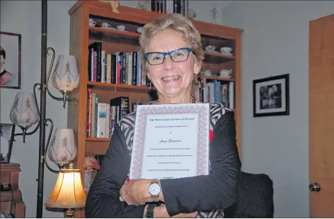  ?? JIM DAY/THE GUARDIAN ?? Anne Stewart-Hume of Murray Harbour proudly embraces a certificat­e awarded by Correction­al Service of Canada for her dedication in offering support to inmates of Dorchester Penitentia­ry.