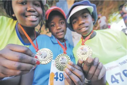  ?? Picture: Alaister Russell ?? PROUD RECIPIENTS. Young runners show off their medals after last year’s The Citizen Trail Run at Sun City. The run features unique views of the resort and Gary Player Golf Course. Proceeds for the race are donated to the Cancer Associatio­n of South...