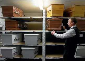  ??  ?? Anthony Beauchamp looks through a selection of caskets.