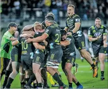  ?? PHOTO/PAUL TAYLOR ?? WINNING FORM: The Hurricanes celebrate their nail-biting victory over the Sharks at McLean Park, Napier, last night.