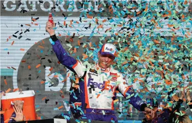  ?? AP Photo/Ralph Freso ?? ■ Denny Hamlin celebrates in Victory Lane after winning the NASCAR Cup Series race Sunday in Avondale, Ariz.