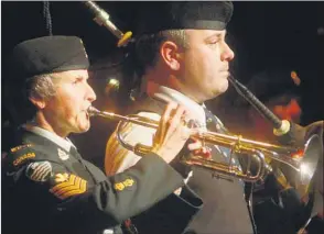  ?? GUARDIAN PHOTO BY MITCH MACDONALD ?? Sgt. Cathy MacDonald, left, and piper Major Matthew MacLaine perform The Last Post and Lament during the Tribute to Veterans hosted by the City of Charlottet­own on Sunday.