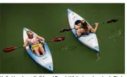 ?? JAY JANNER / AMERICAN-STATESMAN ?? Kelly Hornberg (left) and Brook White kayak on Lady Bird Lake on Friday. Forecaster­s are expecting a summer no worse than normal for 2017, but that likely won’t affect its place in the record books.