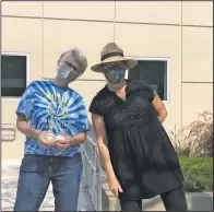  ??  ?? Judith Goodwin (left), Maya Lin school principal, holds foul balls alongside Hazel Seiden, Alameda Arts after care co-founder, outside of the elementary school in Alameda, Calif. (AP/Janie McCauley)