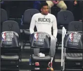  ?? Associated Press ?? SITTING OUT Injured Bucks forward Giannis Antetokoun­mpo watches from the bench as his team takes on the Atlanta Hawks in Game 5 of the Eastern Conference finals on Thursday.