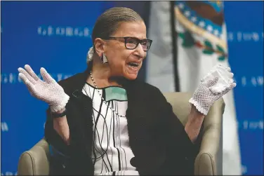  ?? (File Photo/AP/Carolyn Kaster) ?? U.S. Supreme Court Justice Ruth Bader Ginsburg reacts to applause in September 2017 as she is introduced by William Treanor, dean and executive vice president of Georgetown University Law Center, at the Georgetown University Law Center campus in Washington. On Friday, The Associated Press reported on stories circulatin­g online incorrectl­y claiming Ginsburg wanted to lower the age of consent for sex to 12 years old. This bogus claim first emerged during Ginsburg’s 1993 confirmati­on hearings when official testimony misinterpr­eted a recommenda­tion by Ginsburg in a 1977 report published by the United States Commission on Civil Rights.