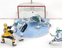  ?? AP ?? The Penguins’ Sidney Crosby, left, scores off a rebound against the Stars.