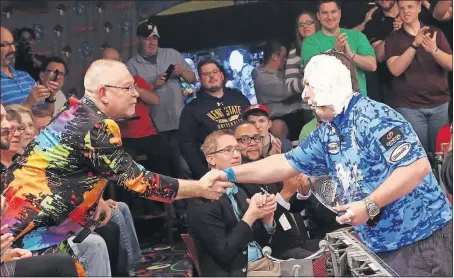  ?? [BROOKE LAVALLEY/DISPATCH] ?? Bowling-alley owner Wayne Webb, left, congratula­tes Tom Smallwood for winning the PBA Barbasol Players Championsh­ip at Wayne Webb’s Columbus Bowl on Sunday.