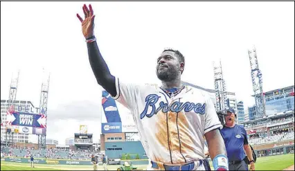  ?? PHOTOS BY SCOTT CUNNINGHAM / GETTY IMAGES ?? Second baseman Brandon Phillips waves to the crowd after his game-winning hit in the 10th inning Saturday afternoon helped beat the Miami Marlins.