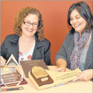  ?? ERIC MCCARTHY/JOURNAL PIONEER ?? Carol Rybinski, left, West Prince Chamber of Commerce secretary and awards committee member, and Tammy Rix, the chamber’s executive director, examine award plaques for design ideas for their 2017 Business Excellence Awards gala. Five awards will be...