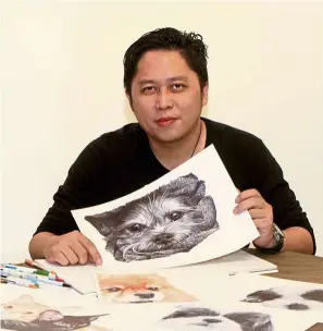  ?? — SAM THAM/The Star ?? Ng chose to draw dogs mainly because he loves pets.