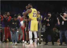  ?? MARCIO JOSE SANCHEZ - THE ASSOCIATED PRESS ?? Los Angeles Lakers forward LeBron James (23) hugs ex teammate and current Miami Heat player Dwyane Wade during the first half of an NBA basketball game Monday, Dec. 10, 2018, in Los Angeles.