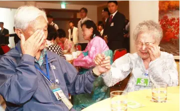  ??  ?? Kim (left), cries with his North Korean sister Sun Ok as they bid farewell at the last meeting of a three-day family reunion event at North Korea’s Mount Kumgang resort.