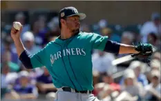  ??  ?? Seattle Mariners starting pitcher Yovani Gallardo throws against the Seattle Mariners during first inning at a spring baseball game Saturday in Scottsdale, Ariz. AP PHOTO