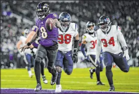  ?? Nick Wass
The Associated Press ?? Ravens QB Lamar Jackson runs to the end zone against the Texans, one of four scores he accounted for in a 34-10 win.