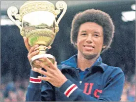  ??  ?? Arthur Ashe raised the trophy at SW19 in 1975