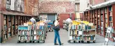  ??  ?? Customers browse the used books for sale from the Brattle Book Shop in an alley in downtown Boston, Massachuse­tts (Reuters)