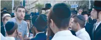  ?? (Udi Shaham) ?? A SECULAR MAN taking part in a protest against religious coercion speaks with Haredim at the corner of Hanevi’im and Dvora Hanevia streets in the capital on October 21.