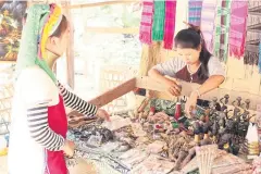  ??  ?? LEFT Learning Coin student Arisa, 17, left, works at her family’s shop in Ban Nai Soi.