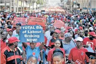  ?? /The Times ?? Protracted battle: Thousands of Cosatu and other union members march in Durban against labour brokers and e-tolls in this file picture. A landmark judgment has ruled that employers who use labour brokers are obliged to permanentl­y employ qualifying temporary staff after three months.