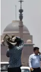  ?? — PTI ?? A person carries an exhaust fan as temperatur­e soars on a hot summer day near Rashtrapat­i Bhavan in New Delhi on Tuesday.